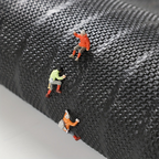 Textured black doormat surface detail with raised grid-like fibers