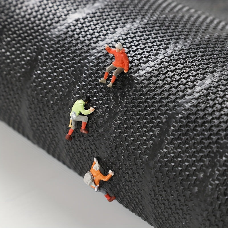 Textured black doormat surface detail with raised grid-like fibers