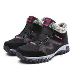 Black winter boots with faux fur collar, hook-and-loop straps, deep lug traction sole