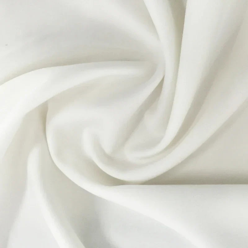 White knit sweater fabric with soft draped texture.