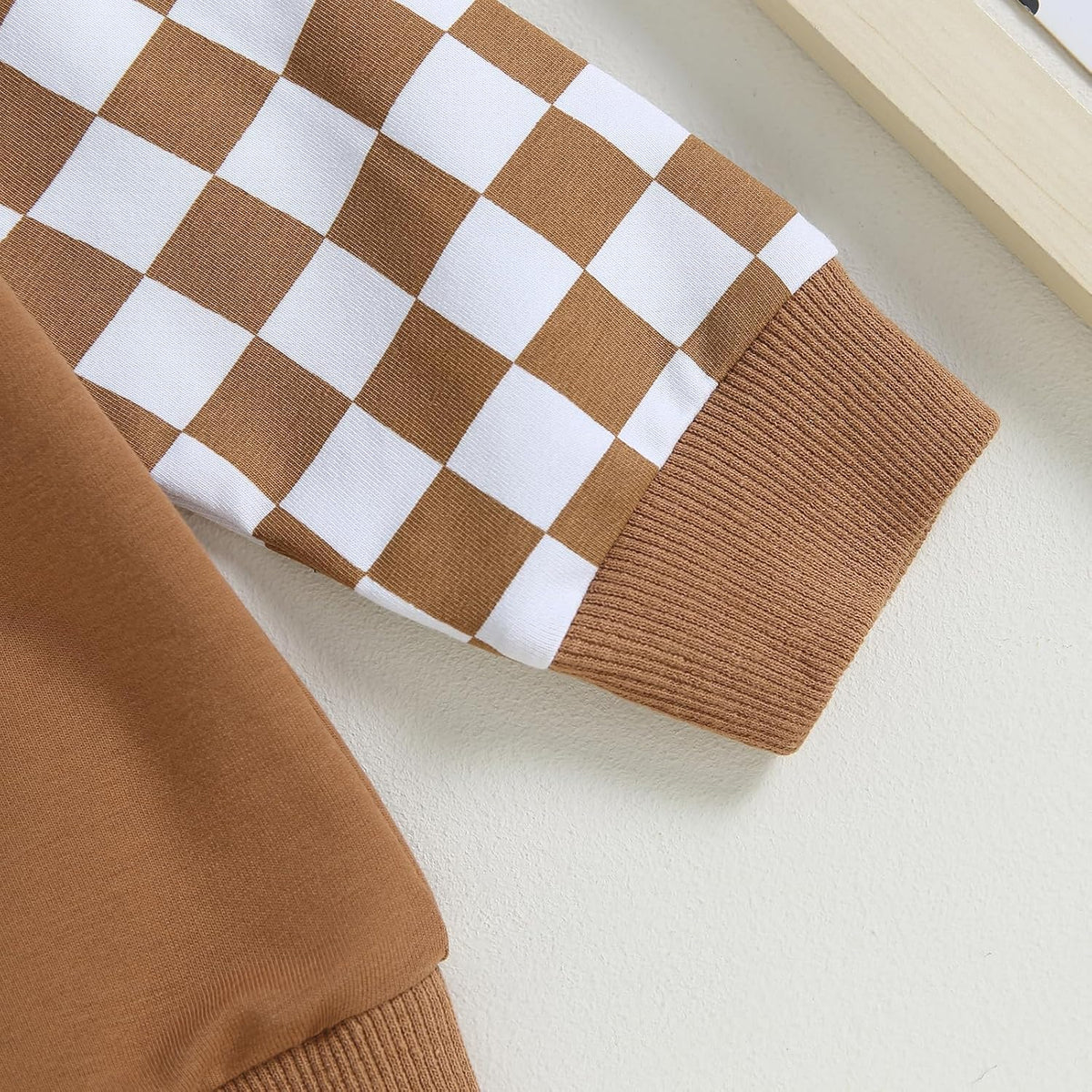 Brown knit jogger pants with white-and-brown checkered side panel