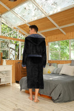 Men's fleece hooded robe with belt and pockets; black robe with dark hood trim.