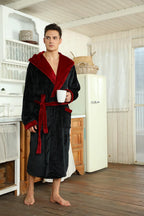 Two-tone hooded fleece robe with red hood lining, belt tie, side pockets, holding mug