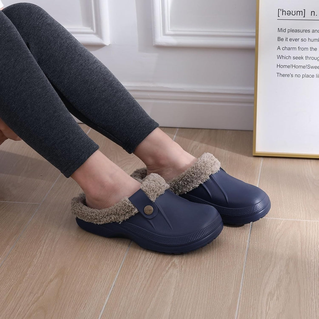 Navy slip-on clogs with plush gray lining, worn indoors on wood floor