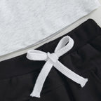 Black pants with white drawstring bow at the waist