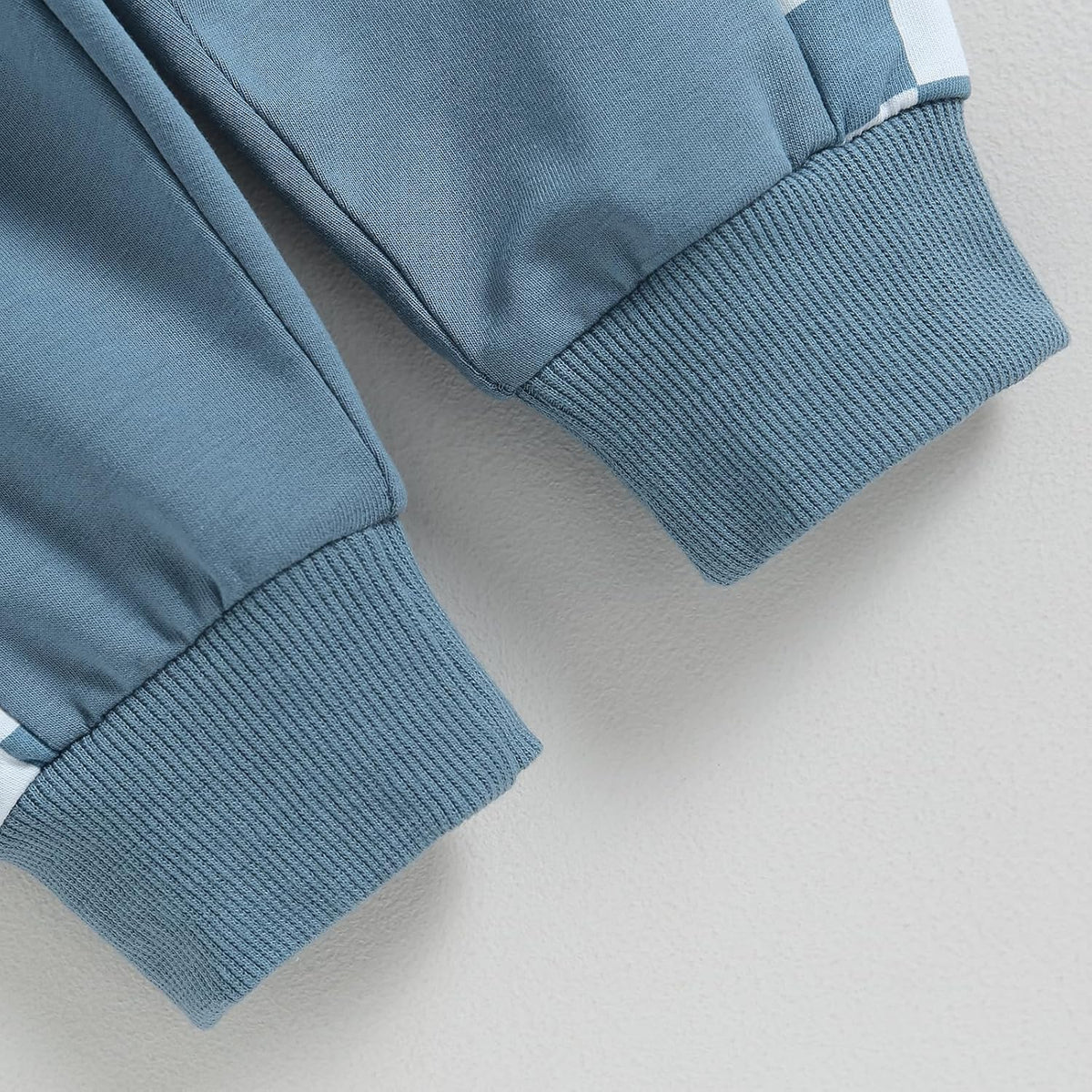 Blue stretch pants with ribbed cuffs and elastic waistband