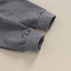 Gray stretch pants with ribbed cuffs and elastic waistband