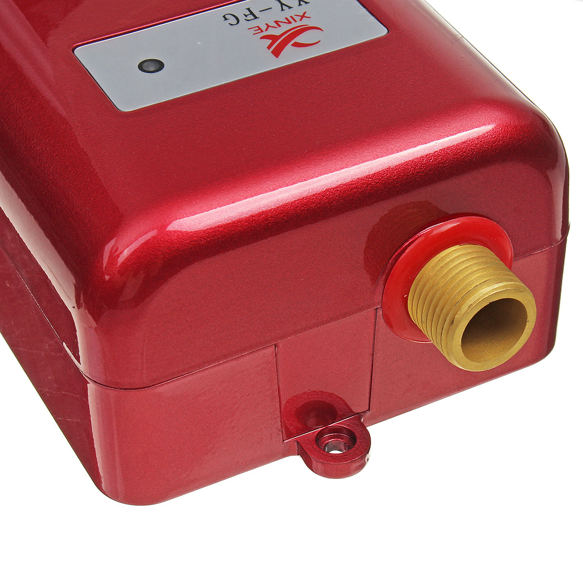 Close-up of red tankless electric water heater with brass inlet fitting