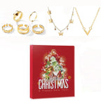 Jewelry pieces with gold-tone necklaces, rings, and earrings beside red Christmas calendar