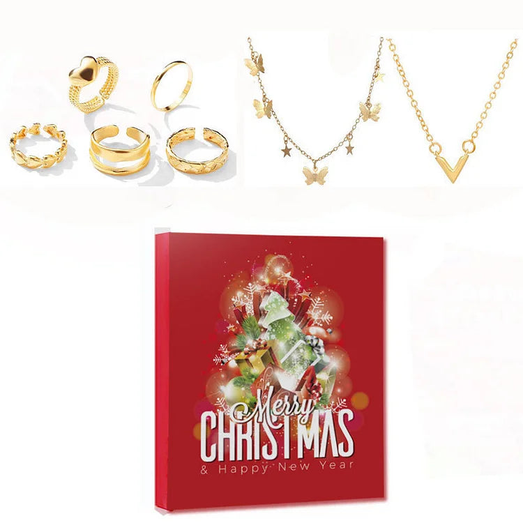 Jewelry pieces with gold-tone necklaces, rings, and earrings beside red Christmas calendar