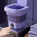 Purple collapsible washing bucket with open lid, control dial and drain spout