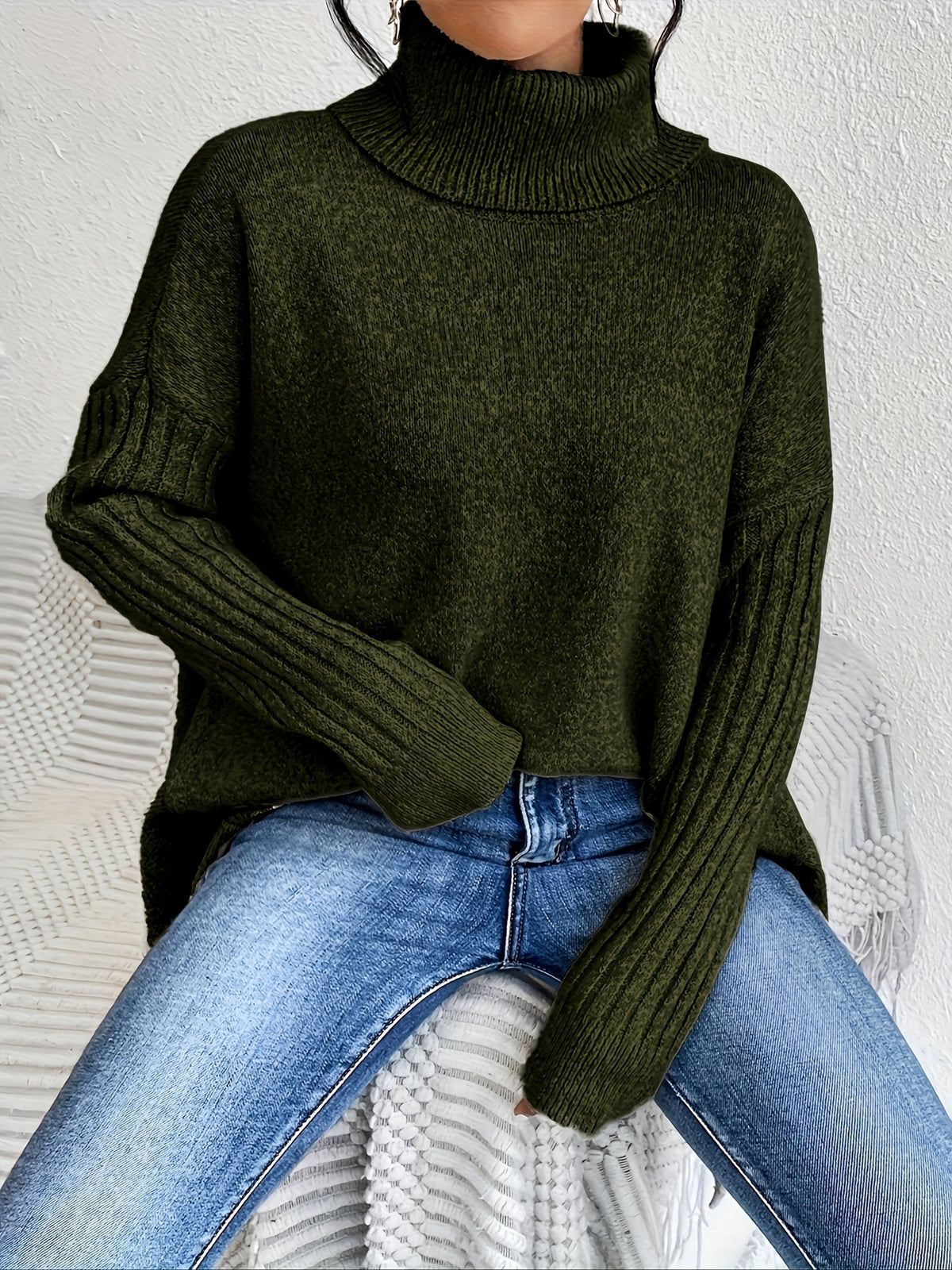 Women’s loose turtleneck sweater, dark green knit with ribbed cuffs and hem.