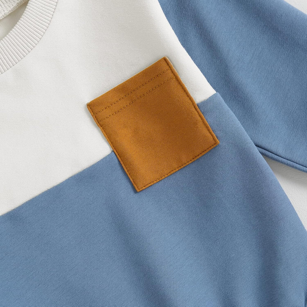 White and blue sweatshirt with tan patch pocket detail