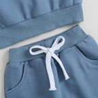Blue jogger pants waistband with white drawstring and ribbed cuff