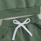 Green jogger pants waistband with white drawstring and elastic hem