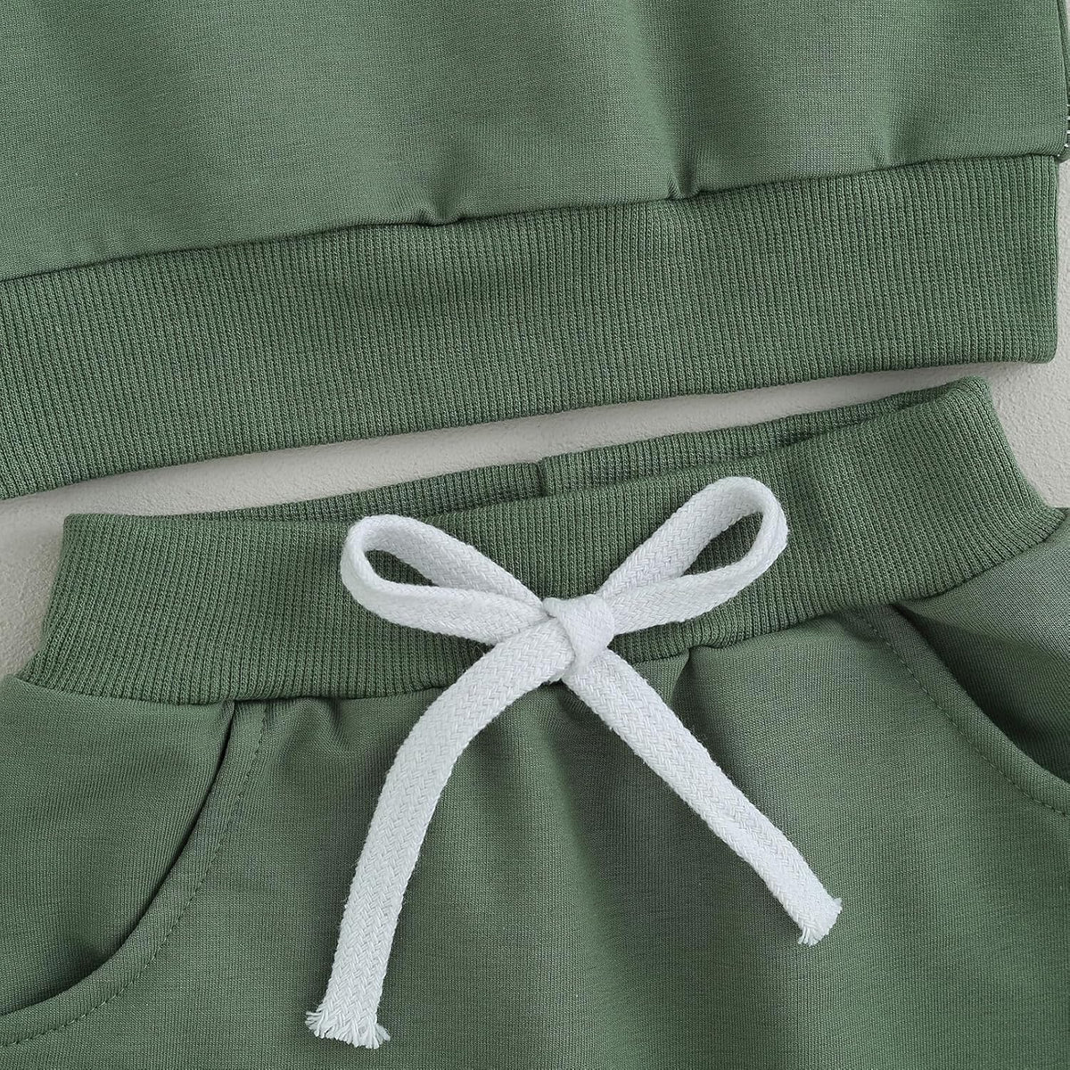 Green jogger pants waistband with white drawstring and elastic hem