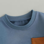 Light blue sweatshirt crew neck with ribbed trim and brown patch