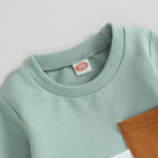 Mint sweatshirt crew neck with gray ribbed collar and brown patch