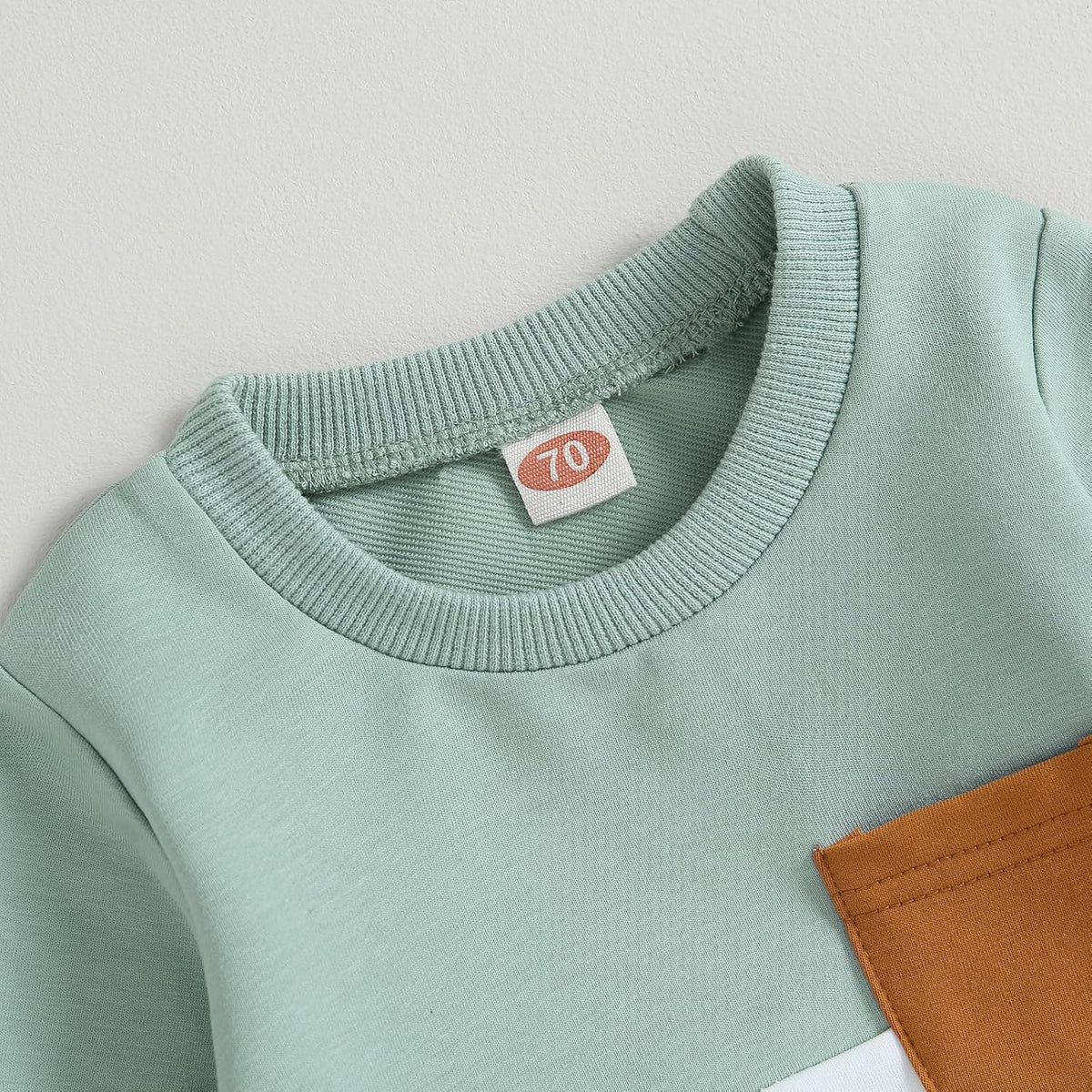 Mint sweatshirt crew neck with gray ribbed collar and brown patch