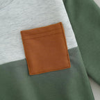 Brown fabric pocket patch on a light blue sweatshirt front