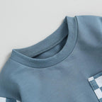 Light blue long-sleeve sweatshirt with ribbed crew neck and checkered detail near hem