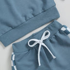Powder blue jogger pants with white drawstring and striped side panel