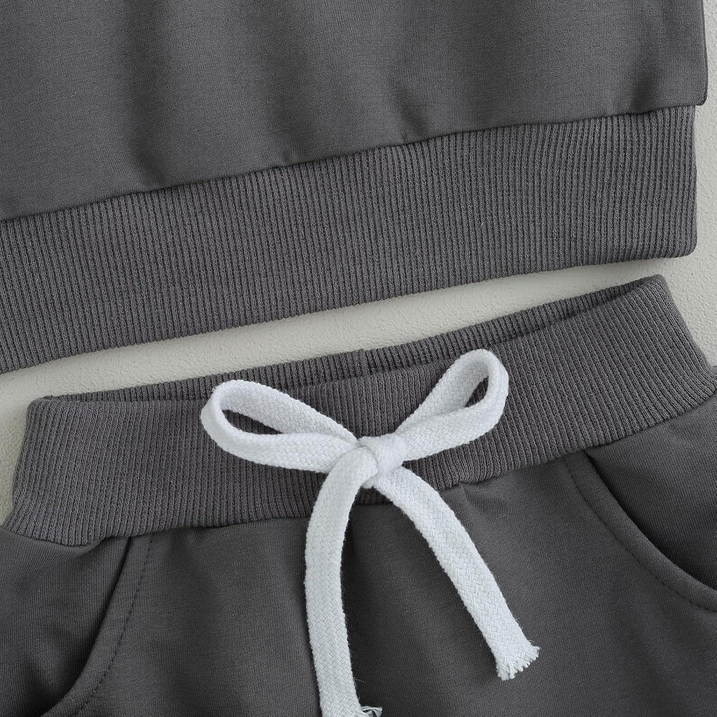 Gray pants waistband with white drawstring and ribbed pant cuffs