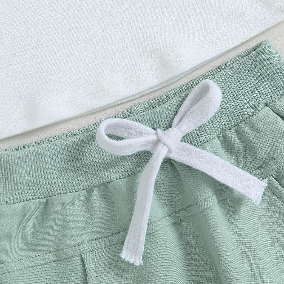 Mint jogger pants with ribbed waistband and white drawstring bow