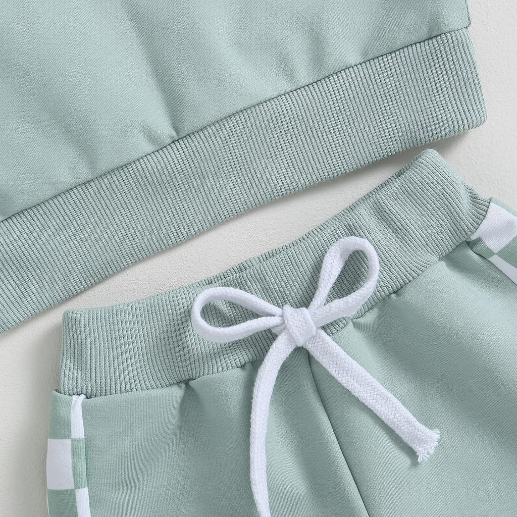 Light blue sweatshirt sleeve cuff and mint jogger waistband with white drawstring