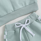 Light blue sweatshirt sleeve cuff and mint jogger waistband with white drawstring