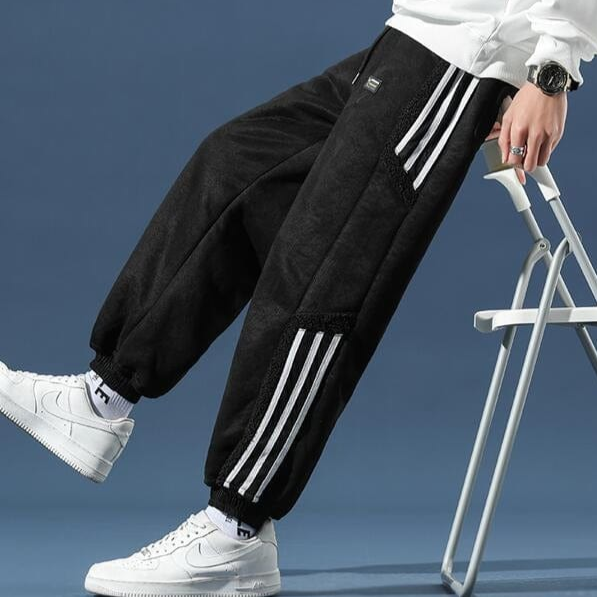 Sherpa-lined black jogger sweatpants with white side stripes and elastic cuffs