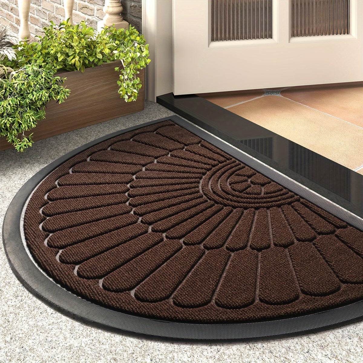 Brown half-round rubber door mat with raised leaf-like traction pattern and thick rim