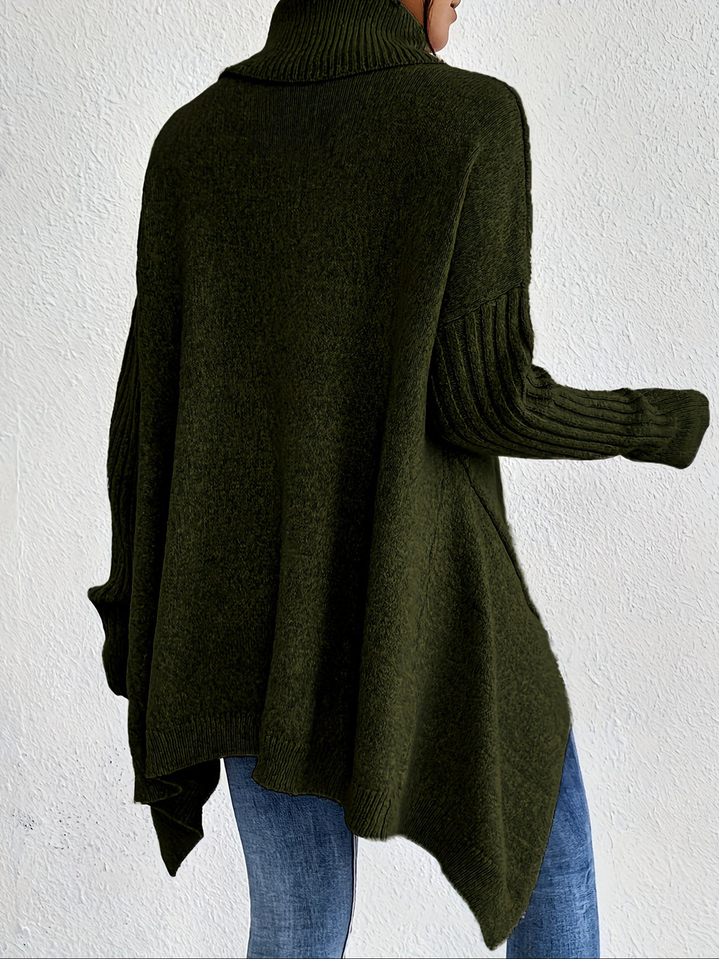 Back view: women’s loose turtleneck sweater, dark green knit with ribbed cuffs.