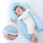 Blue U-shaped baby support cushion with infant lying in the center