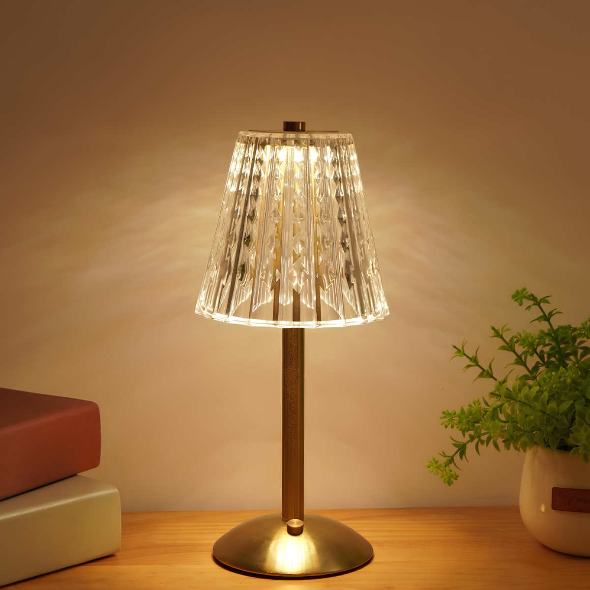 Gold stand table lamp with clear crystal ribbed shade, warm light glowing.