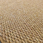 Jute-look doormat surface close-up with tight looped weave in beige.