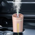 USB humidifier column aroma diffuser, pink body with yellow-green indicator light, emits mist