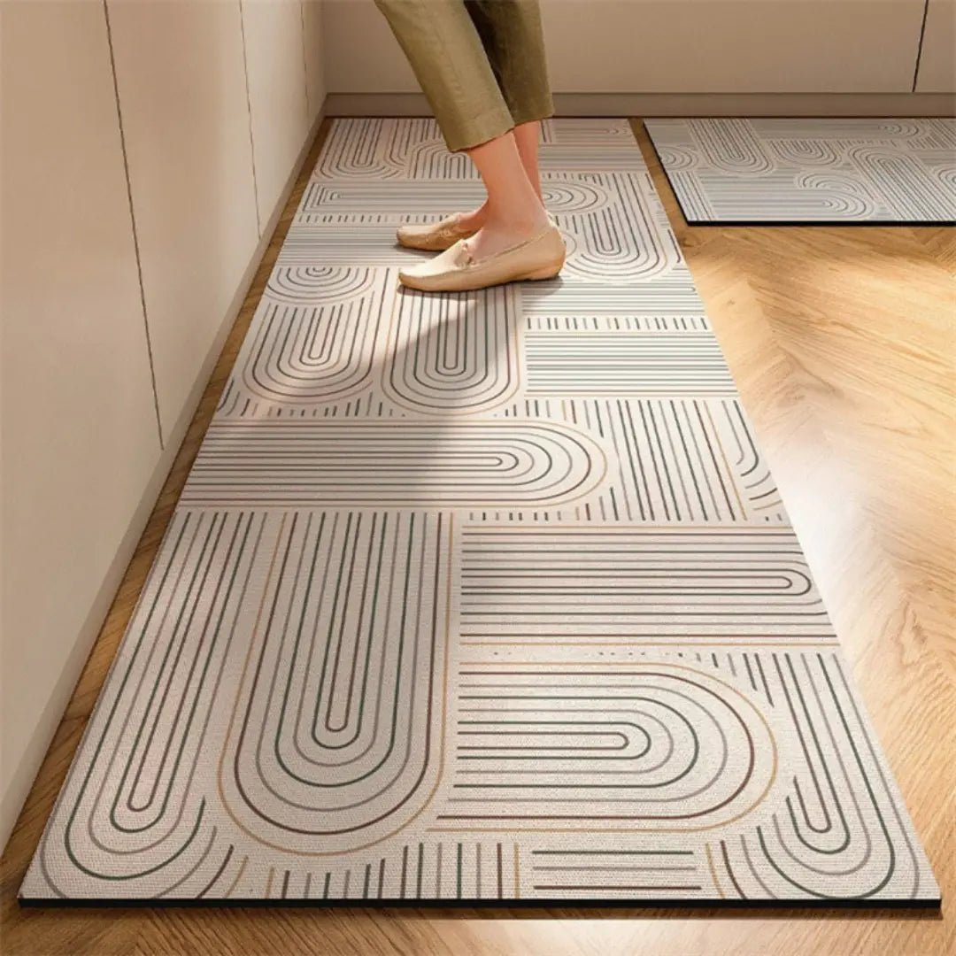 Cream kitchen rug with curving line maze pattern and non-slip rubber backing.