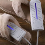 White shoe dryer inserted into a tan boot, showing purple light bar through vents.