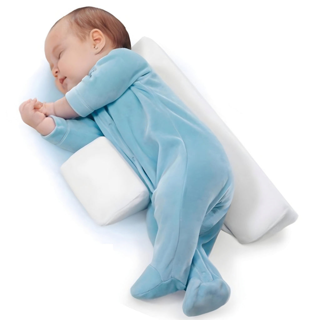 Baby side positioner with white bolsters and adjustable wrap, baby lying on it