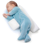 Baby side positioner with white bolsters and adjustable wrap, baby lying on it