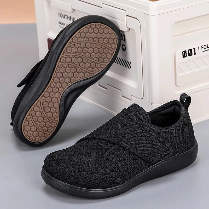 Black slip-on comfort walking shoes with elastic strap detail and textured sole