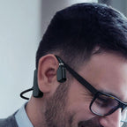 Black open-ear bone conduction wireless headphones worn by man