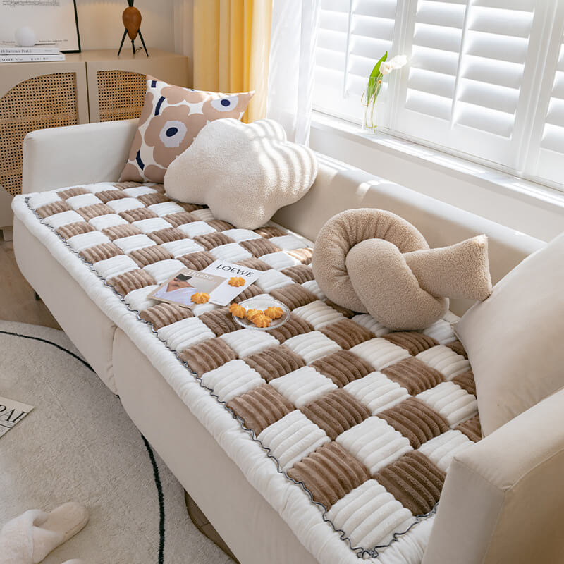 Chenille pet blanket with brown and white striped tiles and scalloped border