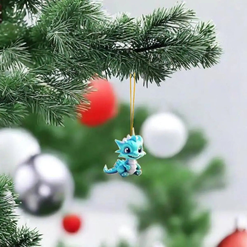 Blue cartoon dragon keychain pendant hanging from Christmas tree branch