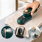 Green mini steam iron on folded fabric, ready to press and steam