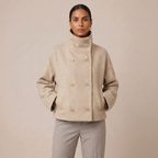 Beige double-breasted pea coat with high funnel neck, buttoned front and flap details