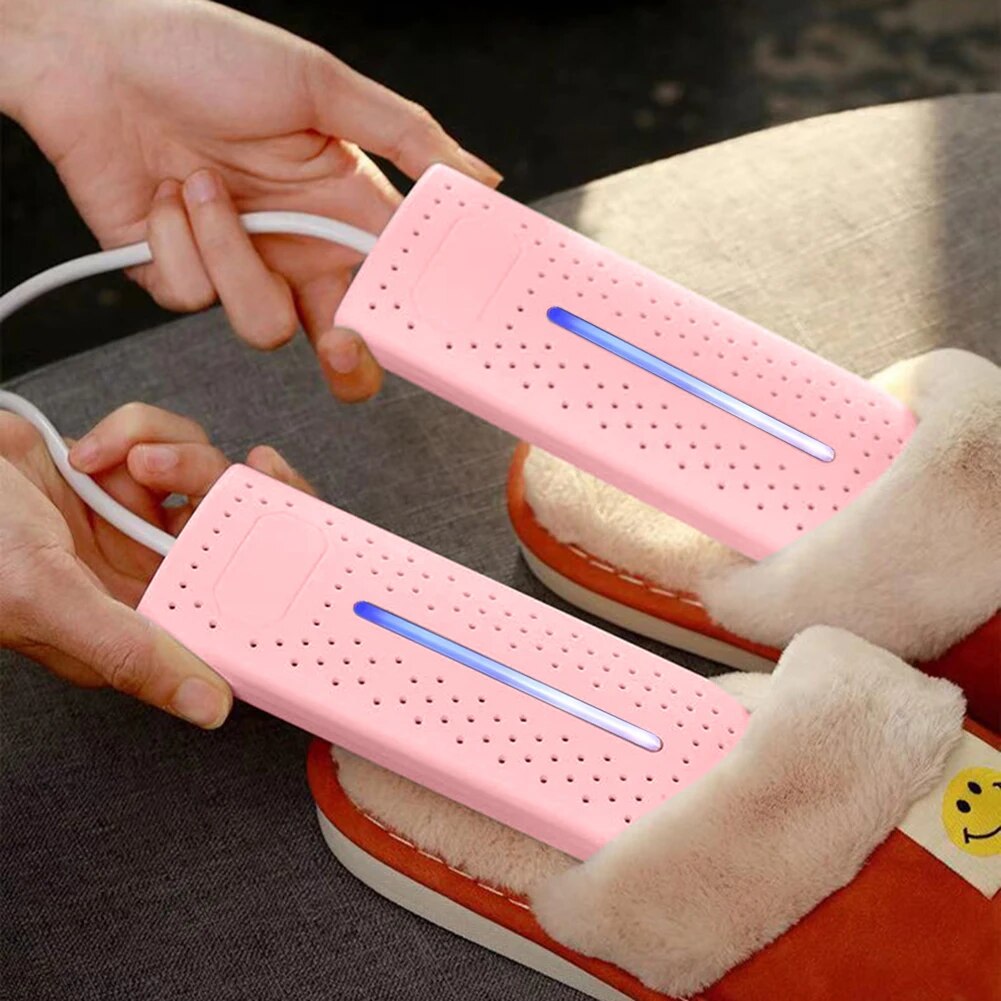 Pink shoe dryers with blue bars, connected by white cords and placed in boots.