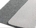 Textured gray shower mat edge detail with lighter backing mesh underside