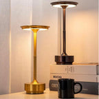 Two cordless LED table lamps with bronze stems and warm glowing round top shades